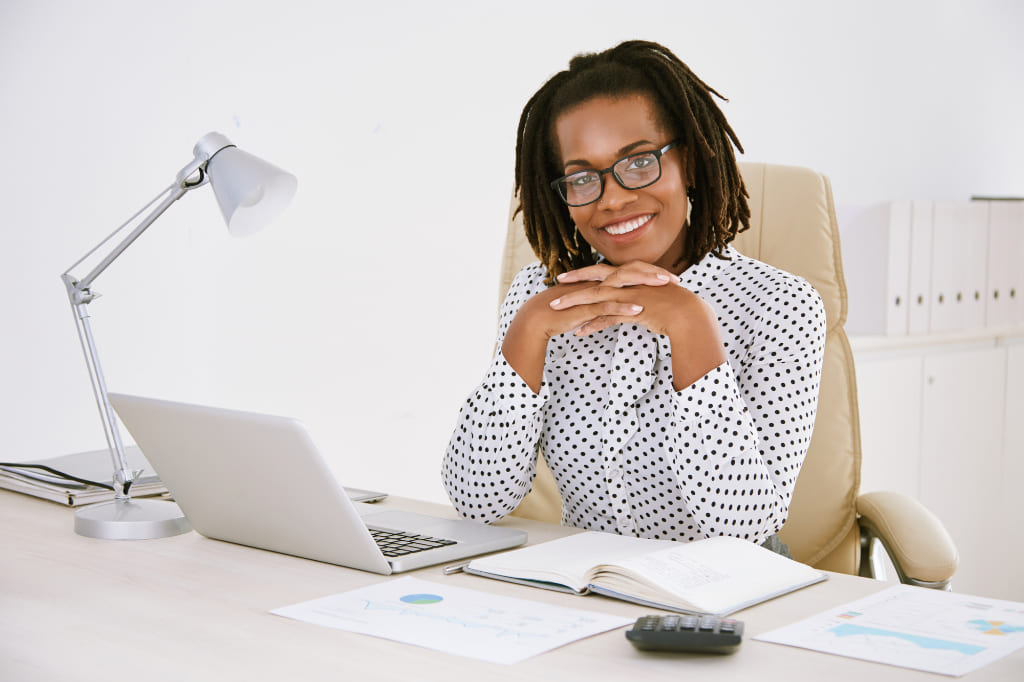 Employee Smiling On Her Desk